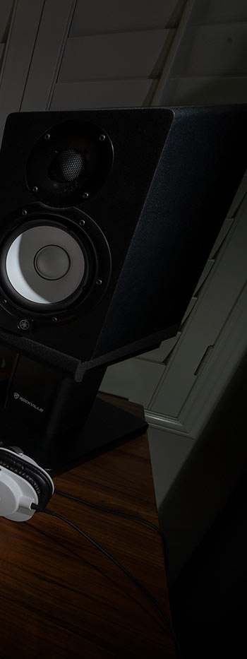 a black speaker on a wood floor